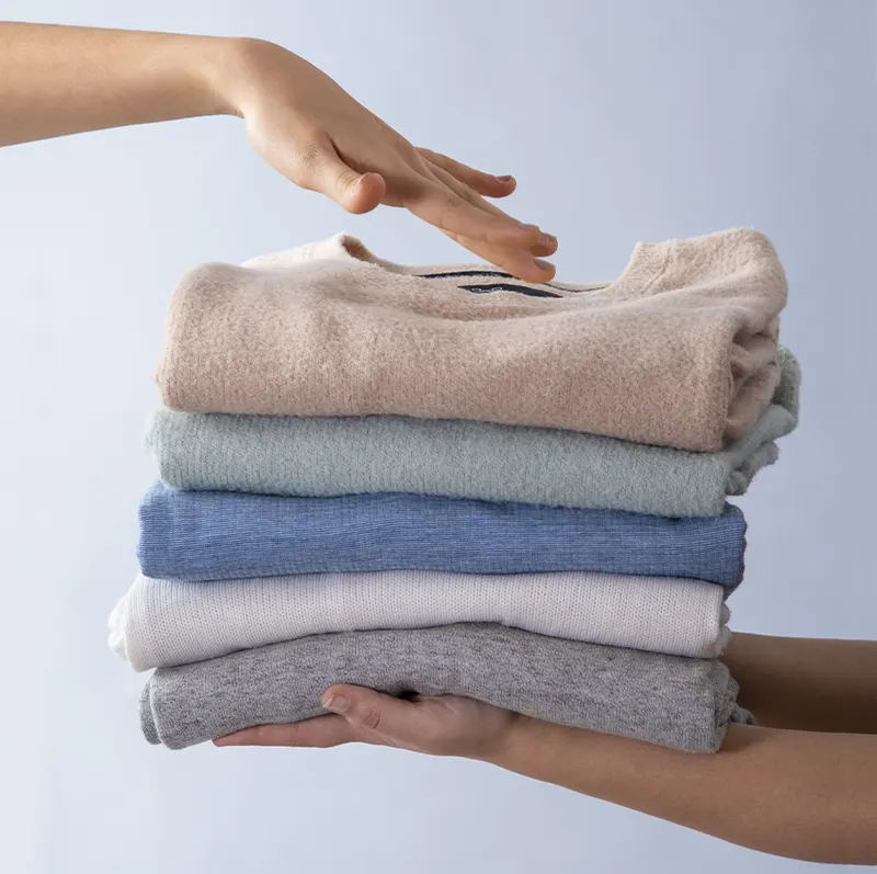 Garment being inspected and finished by a professional dry cleaner